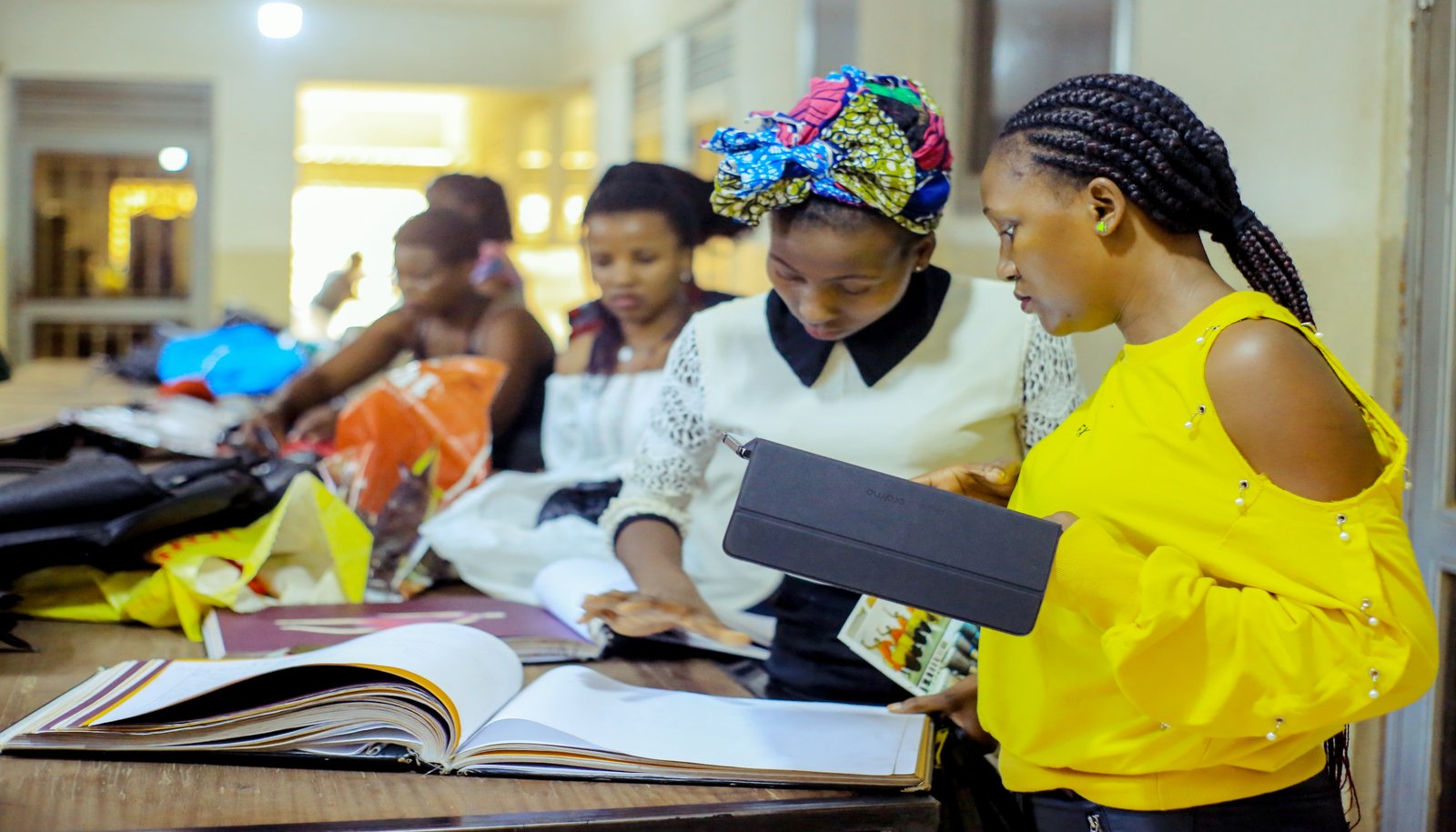 Students at Records Fashion School researching pattern and design books together